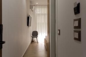 a hallway with a chair next to a window at Sea La Vie Hotel in Durrës
