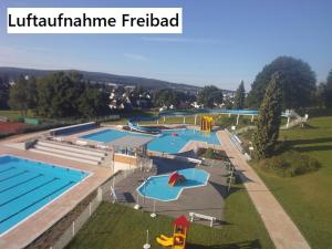 an overhead view of a large swimming pool at DIONYSOS Hotel in Ransbach-Baumbach