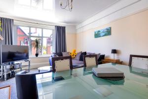a living room with a glass table and a couch at Finest Retreats - Seabreeze, Rhos On Sea in Rhos-on-Sea