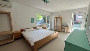 a bedroom with a bed and a desk and a window at Apartmaji Skalabon - Milena in Kanal