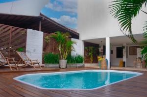 a pool on the deck of a house at Valencia Hotel Natal in Natal