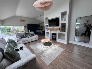 a living room with a couch and a dog laying on a rug at Moate View House in Ballymore Eustace