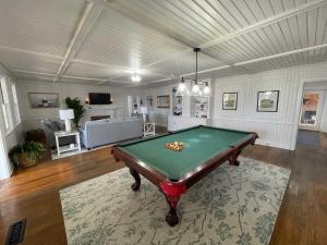 a living room with a pool table in it at 02-Sandbar Suite at The Castle Inn in Ocracoke