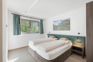a bedroom with two beds and a window at Nature House Pflersch in Brennero
