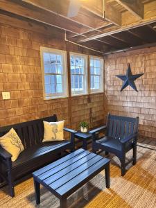 a patio with two benches and a star on the wall at 06-Harbor Suite at The Castle Inn in Ocracoke +7 photos