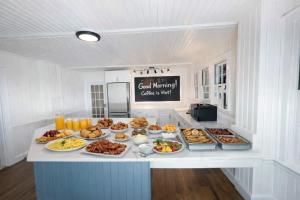 a buffet with many different types of food on a counter at 08-Flight Suite at The Castle Inn in Ocracoke +1 photo