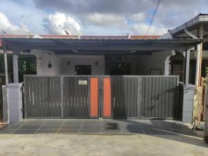 a house with a gate in front of it at Maileyna Homestay 3 in Alor Setar