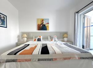 a white bedroom with a large bed and a window at Sunset Haven Algarve in Albufeira +78 photos