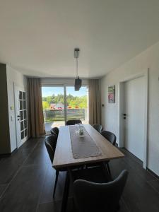 a living room with a wooden table and chairs at Apartment by Ela in Alpirsbach