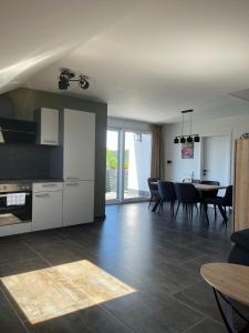 a living room with a kitchen and a dining room at Apartment by Ela in Alpirsbach
