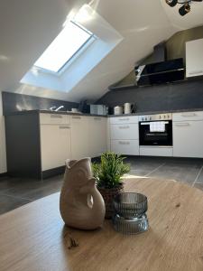 a kitchen with a table with a vase on it at Apartment by Ela in Alpirsbach +10 photos
