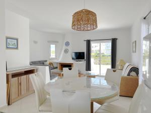 a dining room and living room with a table and chairs at Sunset Haven Algarve in Albufeira
