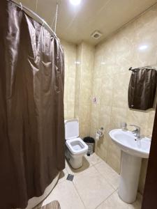 a bathroom with a toilet and a sink at Hotel Nirvana in Tbilisi City
