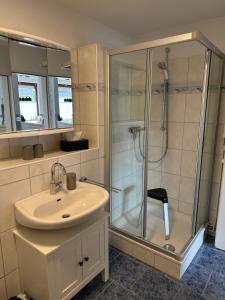 a bathroom with a shower and a sink and a shower at Birkenweg Ankerplatz II in Carolinensiel +22 photos