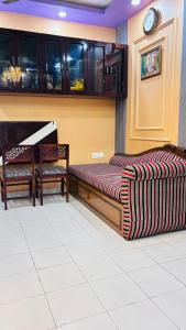 a room with a bed and a piano in a room at Kaushani Homes in Nangi
