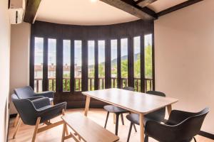 a table and chairs in a room with a large window at Hotel Casa Juan in Ayegui