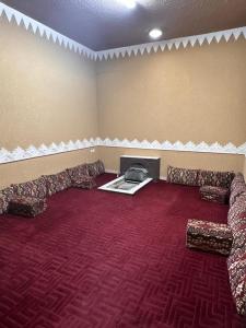 a large room with couches and a fireplace at شالية درة الرحاب in Buraydah