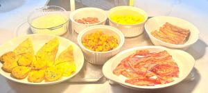 a table topped with bowls of different types of food at 07-Founders Suite at The Castle Inn in Ocracoke