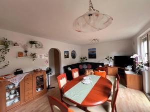 a living room with a table and a couch at Green Garden Home in Cerknica