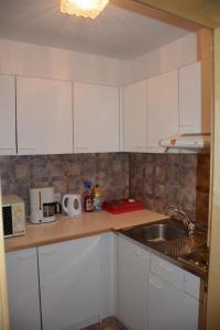 a kitchen with white cabinets and a sink at Haus Schimpfößl in Flirsch