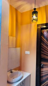 a bathroom with a toilet and a sink at Kaushani Homes in Nangi