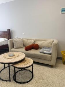 a living room with a couch and two tables at Jambo luxury living in Marimbeti