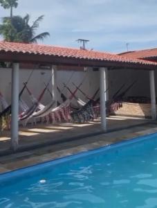 a resort with a swimming pool and a house at Pousada Vela dos Ventos in Praia de Moitas +31 photos