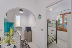 a kitchen with a sink and a refrigerator at Villa Damiano in Tertenìa