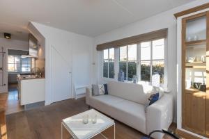 a living room with a couch and a table at Welcome in - Appartement met zonnig terras, nabij centrum Zoutelande I Borne 56a in Zoutelande