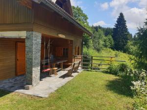 a porch of a house with a table and a fence at Ferienhaus 146 in Arnoldstein