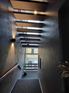 a hallway with a stairway with a window and a ceiling at Double Room 1 with free parking in Saeby in Sæby