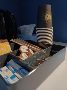 a box on a table with a stack of plates at Double Room 1 with free parking in Saeby in Sæby