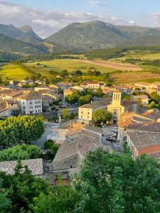 an aerial view of a town with mountains in the background at Oustal de Bourdeaux in Bourdeaux