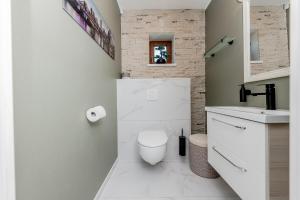 a bathroom with a toilet and a sink at Valgekodu Pesa in Papsaare