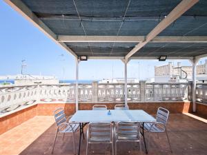 a table and chairs on the roof of a building at La Terrazza del Gabbiano in Cozze +36 photos