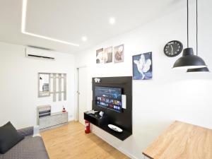 a living room with a flat screen tv on a wall at La Terrazza del Gabbiano in Cozze