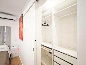 a bedroom with white walls and a closet at La Terrazza del Gabbiano in Cozze