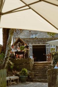 a group of people sitting at a table in a yard at Bankes Arms Hotel in Wareham