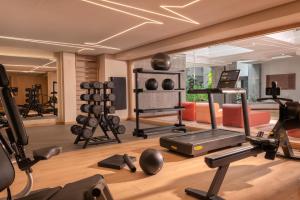 a gym with exercise equipment in a room at Plus Fariones Suite Hotel in Puerto del Carmen