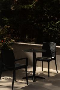 two chairs and a table and a table and chairs at Sea La Vie Hotel in Durrës