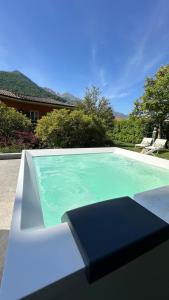 a swimming pool with a black box on top of it at Boutique Hotel Villa Cuserina wellness in Cannobio