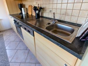 a kitchen with a sink and a counter top at EifelRuhe 3 in Hellenthal - ideal für Familien und Paare mit Hund - voll ausgestattete Küche und zwei Schlafzimmer in Hellenthal