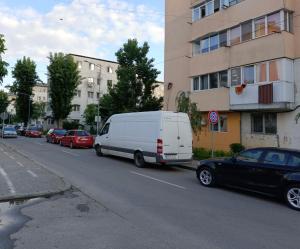 a white van parked on the side of a street at Mini Studio Aristocrat in Târgovişte
