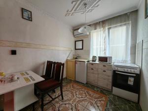 a small kitchen with a table and a stove at Lenny in Kranevo