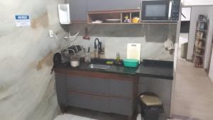 a small kitchen with a sink and a microwave at Hostel da Floresta in Vitória +17 photos