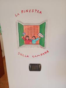 a door with a picture of two people in bed at La finestra sulla campana in Brescello +1 photo