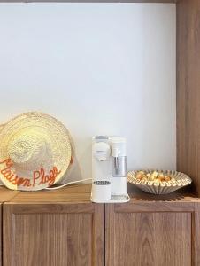 a coffee machine sitting on top of a wooden table at Maison Plage - boutique hôtel in Saint-Brevin-les-Pins +51 photos