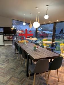 a dining room with a large wooden table and chairs at Hotel Krebuli in Kazbegi