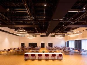 a large room with rows of tables and chairs at Novotel Convention And Spa in Antananarivo +181 photos