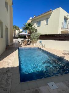 a swimming pool in front of a house at Villa Flory in Protaras